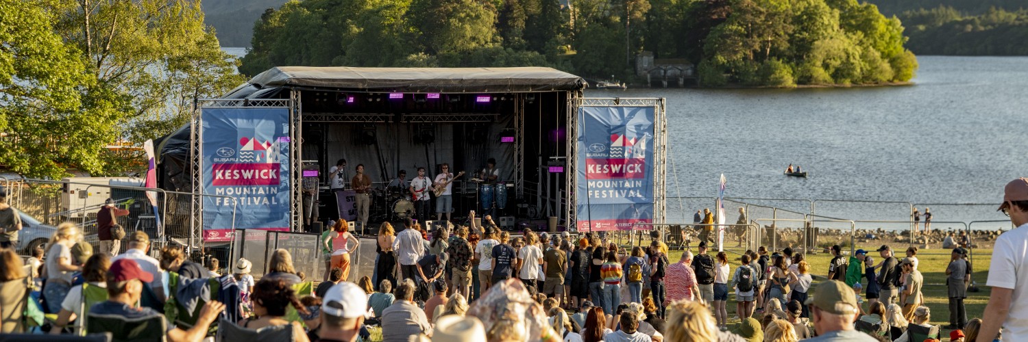 Visitors watch the stage at Keswick Mountain Festival in Keswick, Lake District